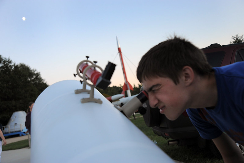 Child looking through telescope International Observe the Moon Night