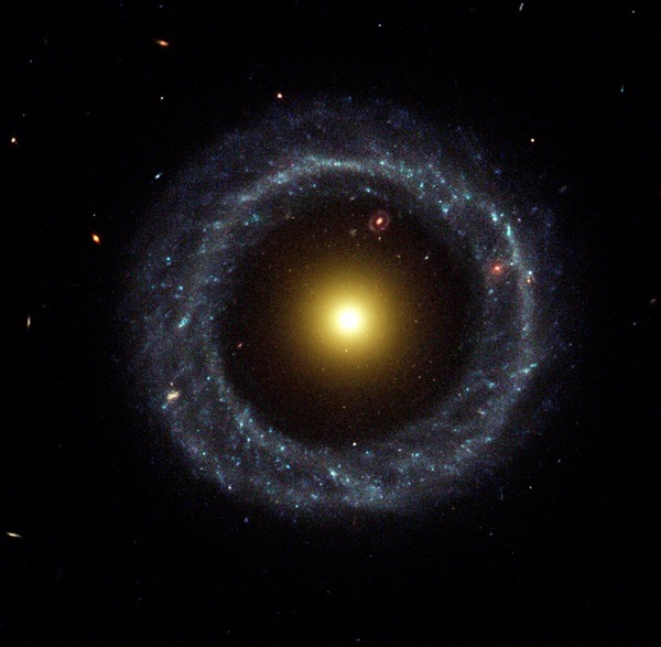 This artist’s impression portrays pulsar PSR B1257+12 as a small point of light in the distance, with its three planets bombarded by lethal X-ray and gamma-ray radiation. Credit: NASA/JPL-Caltech