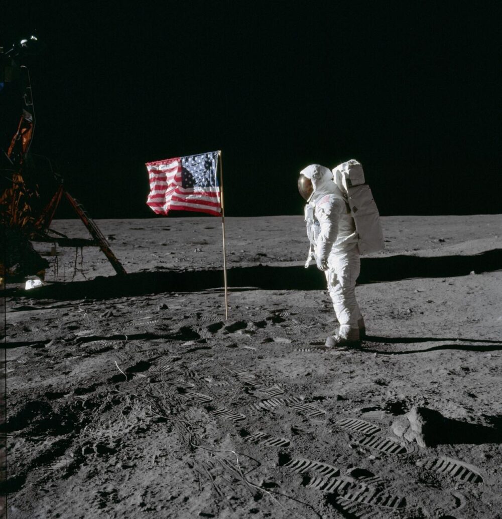 Edwin E. "Buzz" Aldrin Jr. poses for a photograph beside the American flag on the Moon. The footprints of the astronauts are visible in the soil of the Moon. Neil A. Armstrong took this picture with a 70mm Hasselblad lunar surface camera. Credit: NASA.