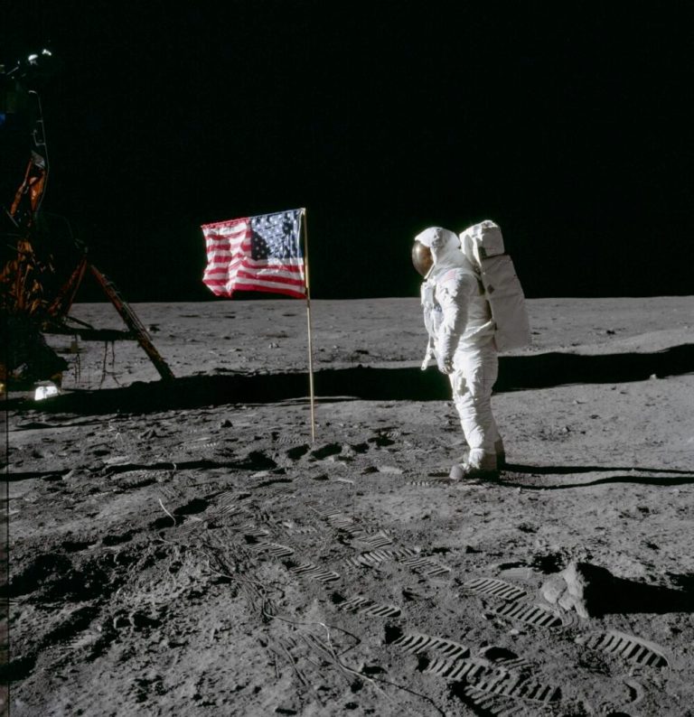 Edwin E. "Buzz" Aldrin Jr. poses for a photograph beside the American flag on the Moon. The footprints of the astronauts are visible in the soil of the Moon. Neil A. Armstrong took this picture with a 70mm Hasselblad lunar surface camera. Credit: NASA.