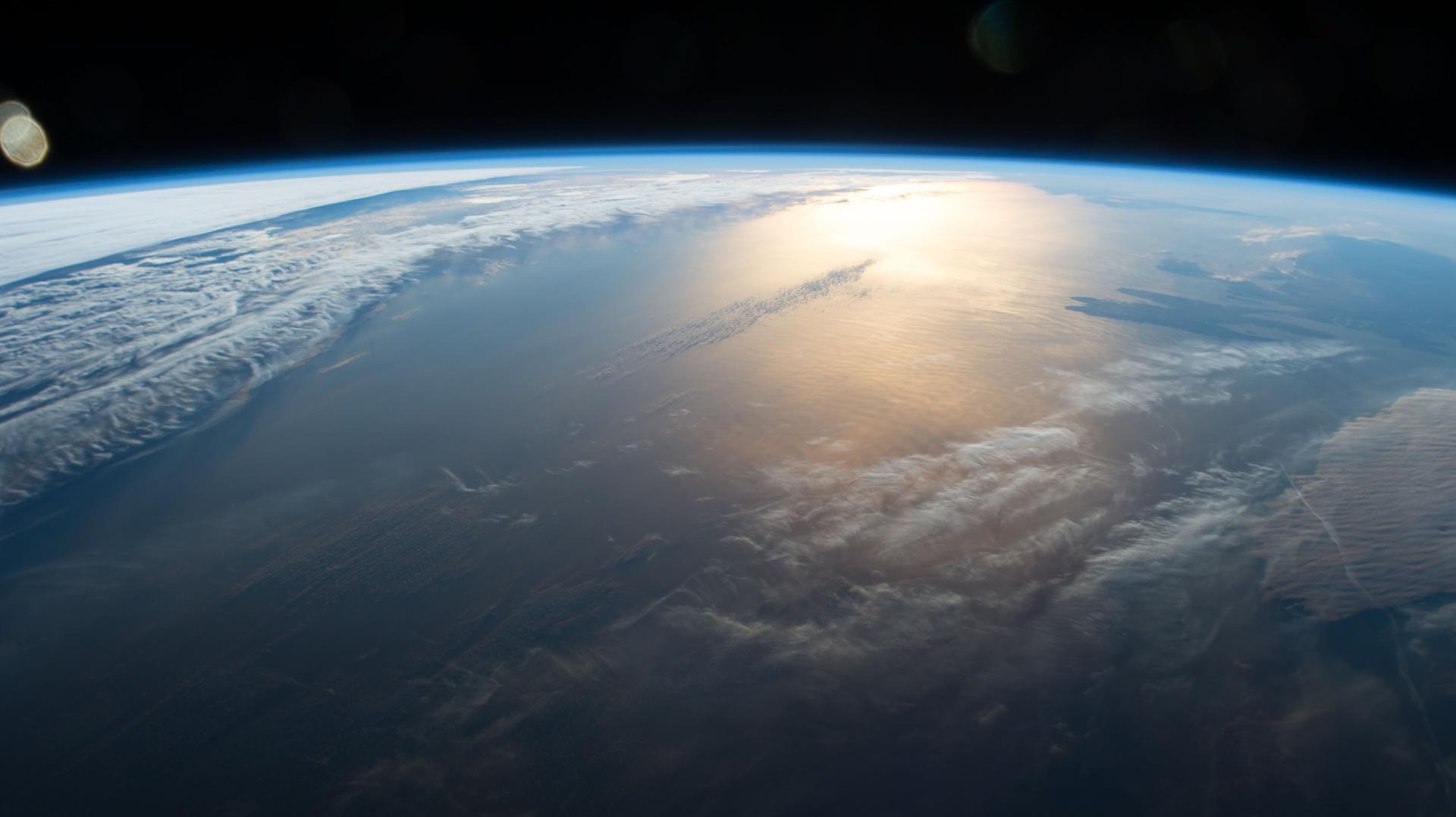 The Sun rises slowly spreading a golden glow over Earth in this image taken from the International Space Station. Credit: NASA.