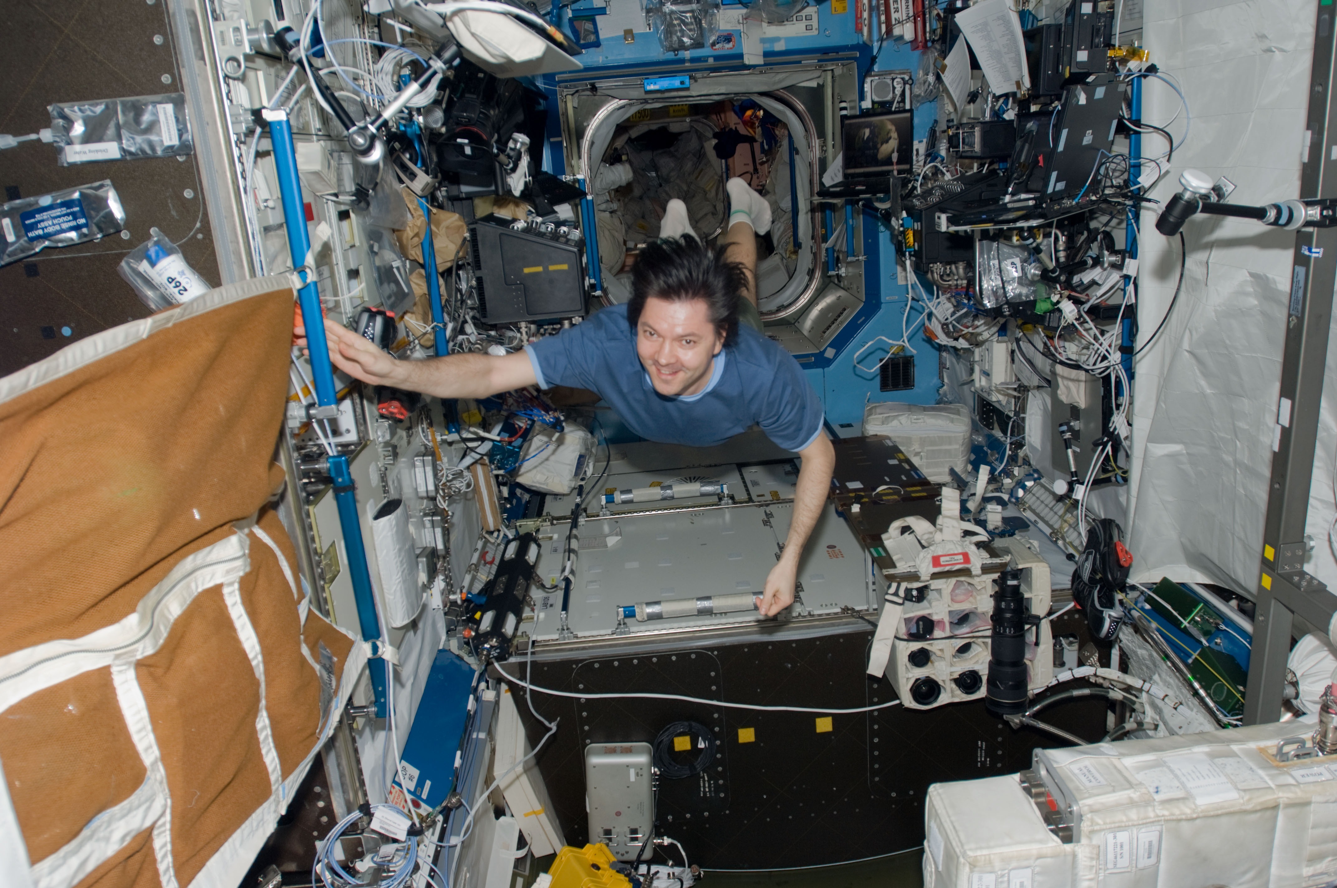 Oleg Kononenko floats through the Destiny laboratory of the International Space Station in 2008. Credit: NASA.