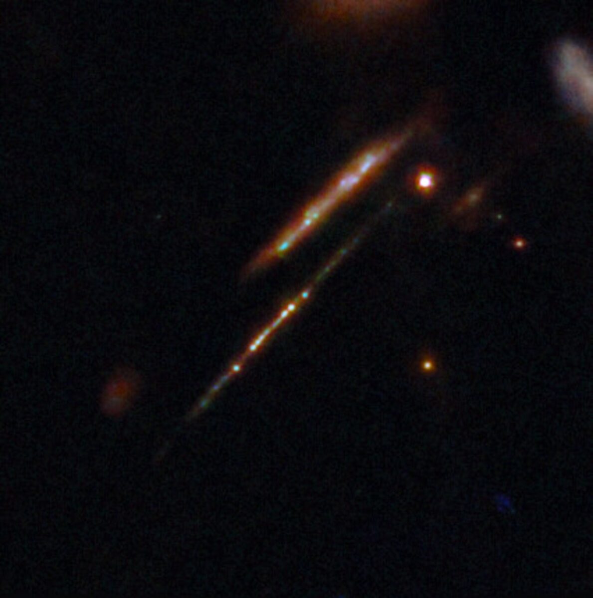 This image shows a portion of the lensing galaxy cluster SPT-CL J0615−5746. Two distinct lensed galaxies are visible, of which the lower galaxy (known as the Cosmic Gems Arc) is shown with several star clusters within. Credit: ESA/Webb, NASA & CSA, L. Bradley (STScI), A. Adamo (Stockholm University) and the Cosmic Spring collaboration