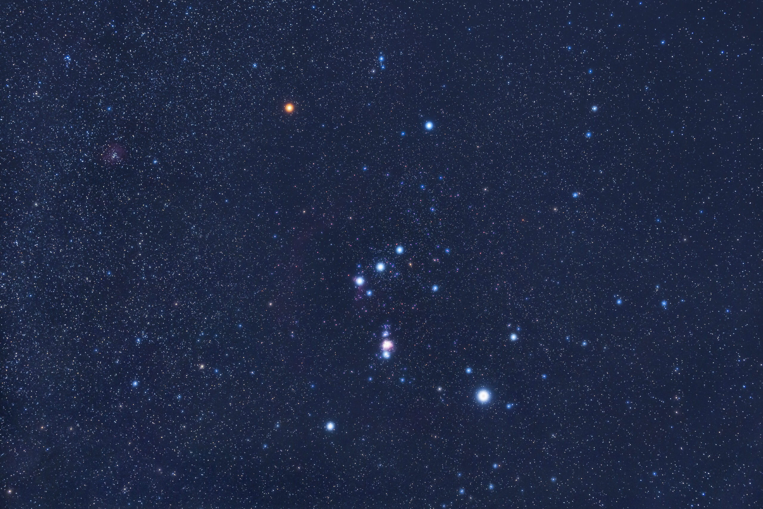 The constellation Orion the Hunter hosts two of the 10 brightest stars in the sky, Betelgeuse and Rigel. At magnitude 0.5 and 0.2, respectively, Betelgeuse (orange star at upper left) and Rigel (blue-white star at lower right) stand in stark contrast to many of the surrounding stars.