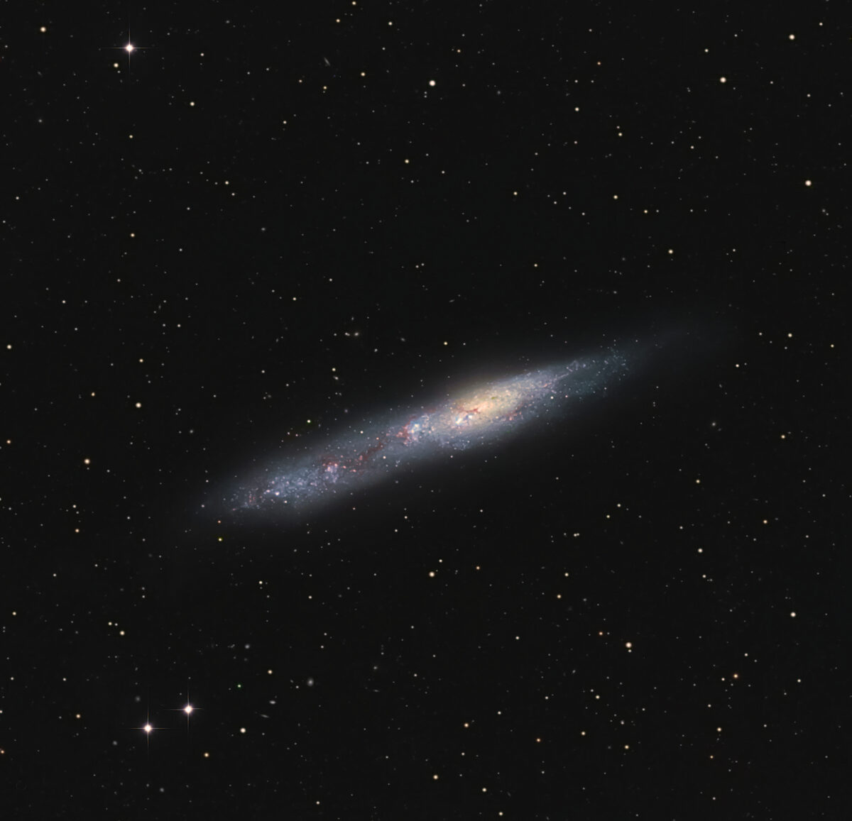NGC 55’s oblong shape gives it an uncanny resemblances to the Cigar Galaxy (M82). 