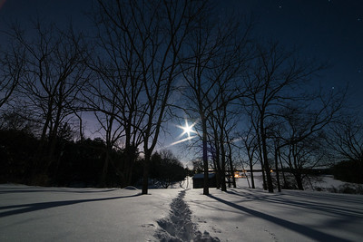 Full Moon shining over snowy landscape
