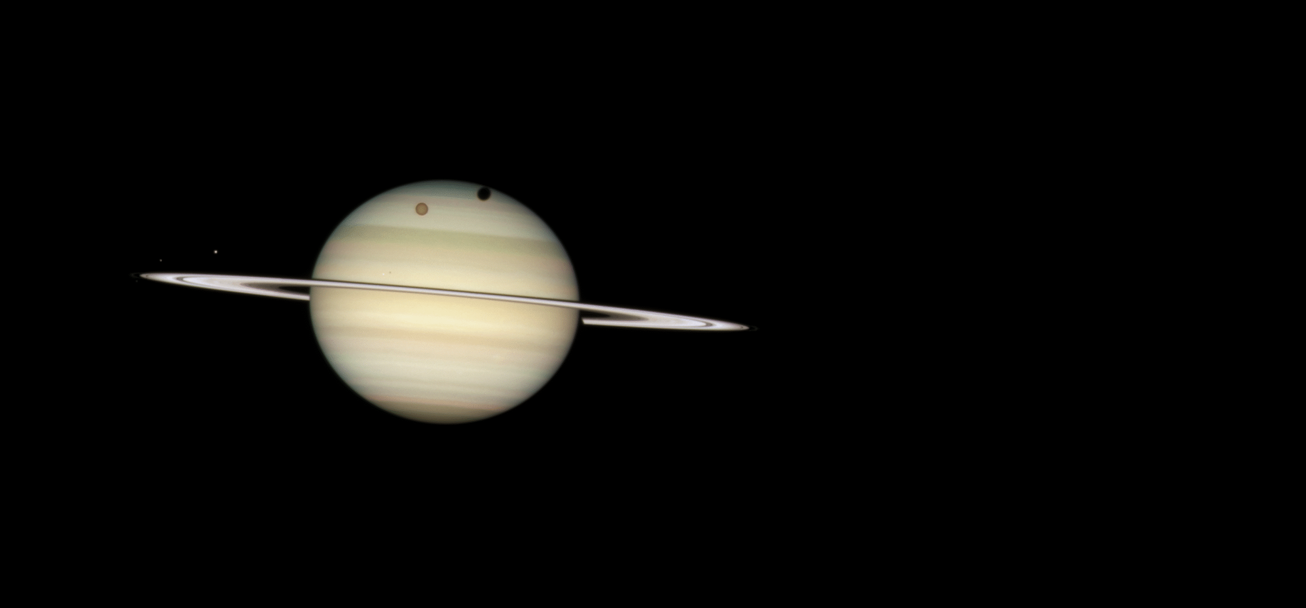 Titan and its shadow transit Saturn