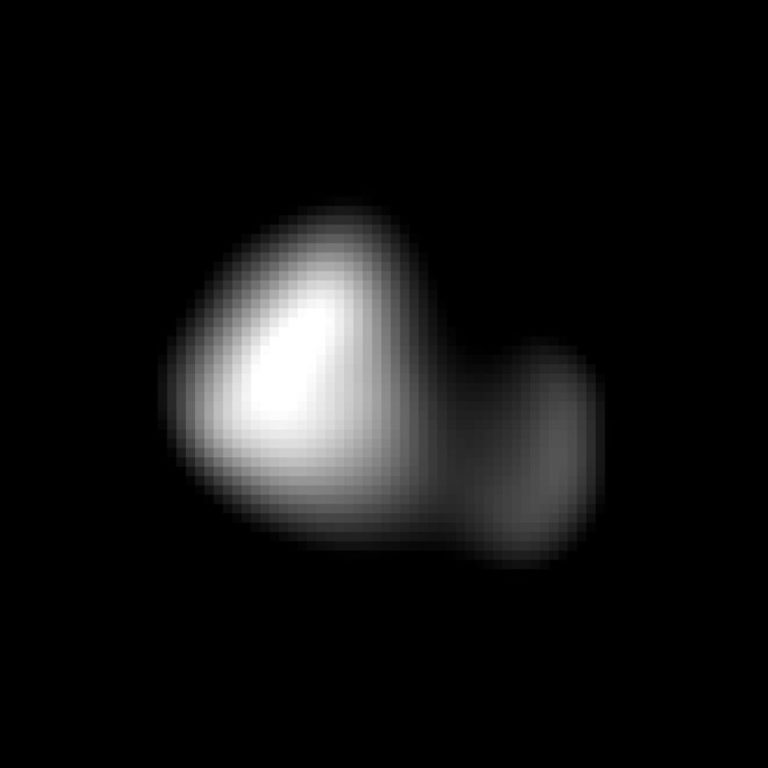 A highly pixelated, black-and-white image features a single blurry object floating against a pitch-black background. The subject appears to have two connected sections: a larger, brighter rounded shape on the left and a smaller, dimmer lobe extending to the right. The contrast is sharp between the solid black void and the glowing, blocky white patches of the central object.