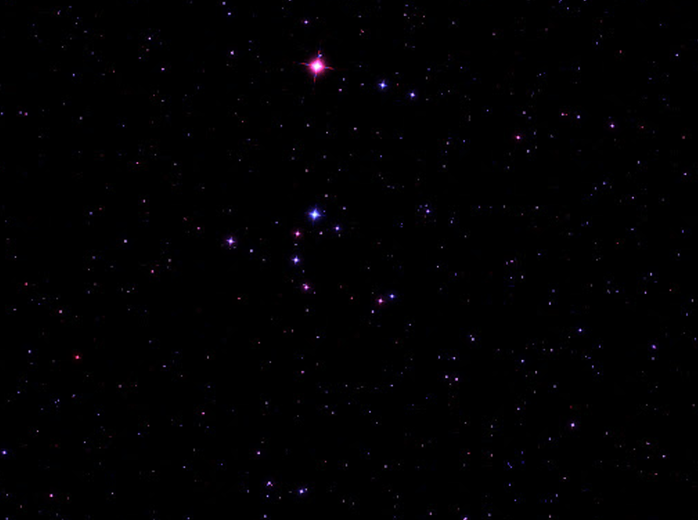 The Broken Engagement Ring asterism, a semicircle of stars of varying brightness and color, set against the dark night sky near the star Merak in Ursa Major.