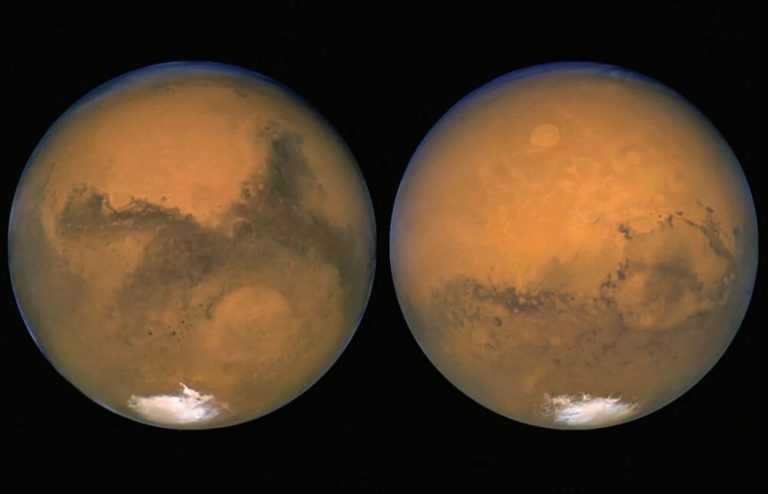 Two side-by-side full-disk views of a round, reddish-orange planet are set against a solid black background. Both spheres feature mottled dark grey and brown surface markings across their centers, a thin blue atmospheric rim along their edges, and a bright white ice cap at the bottom pole. Soft lighting illuminates the terrain, creating sharp contrast between the bright orange surface and the dark void surrounding each planet.