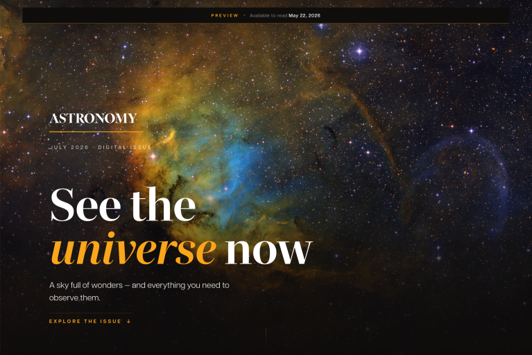 A screenshot of the July 2026 issue landing page. The hero image features a bright deep-space scene with a glowing blue core of a nebula, wrapped in thick, textured clouds of amber and brown gas and dust. Sharp white stars fill the outer regions of the frame, with a few brighter stars showing cross-shaped spikes.