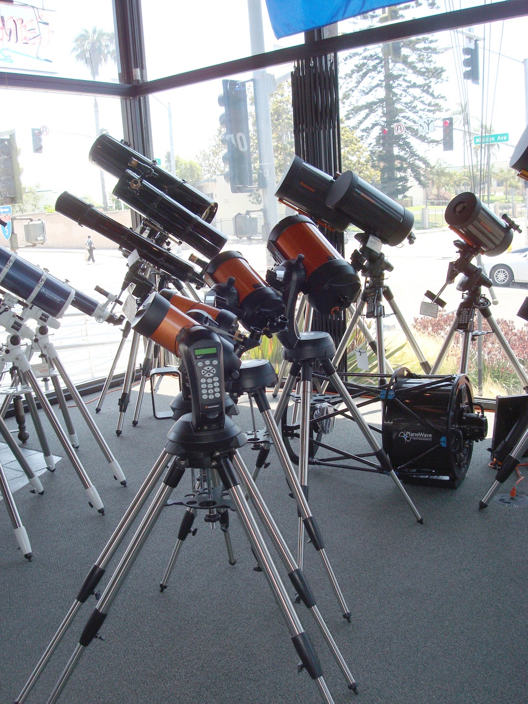 Interior of an astronomy shop with rows of telescopes and equipment on display