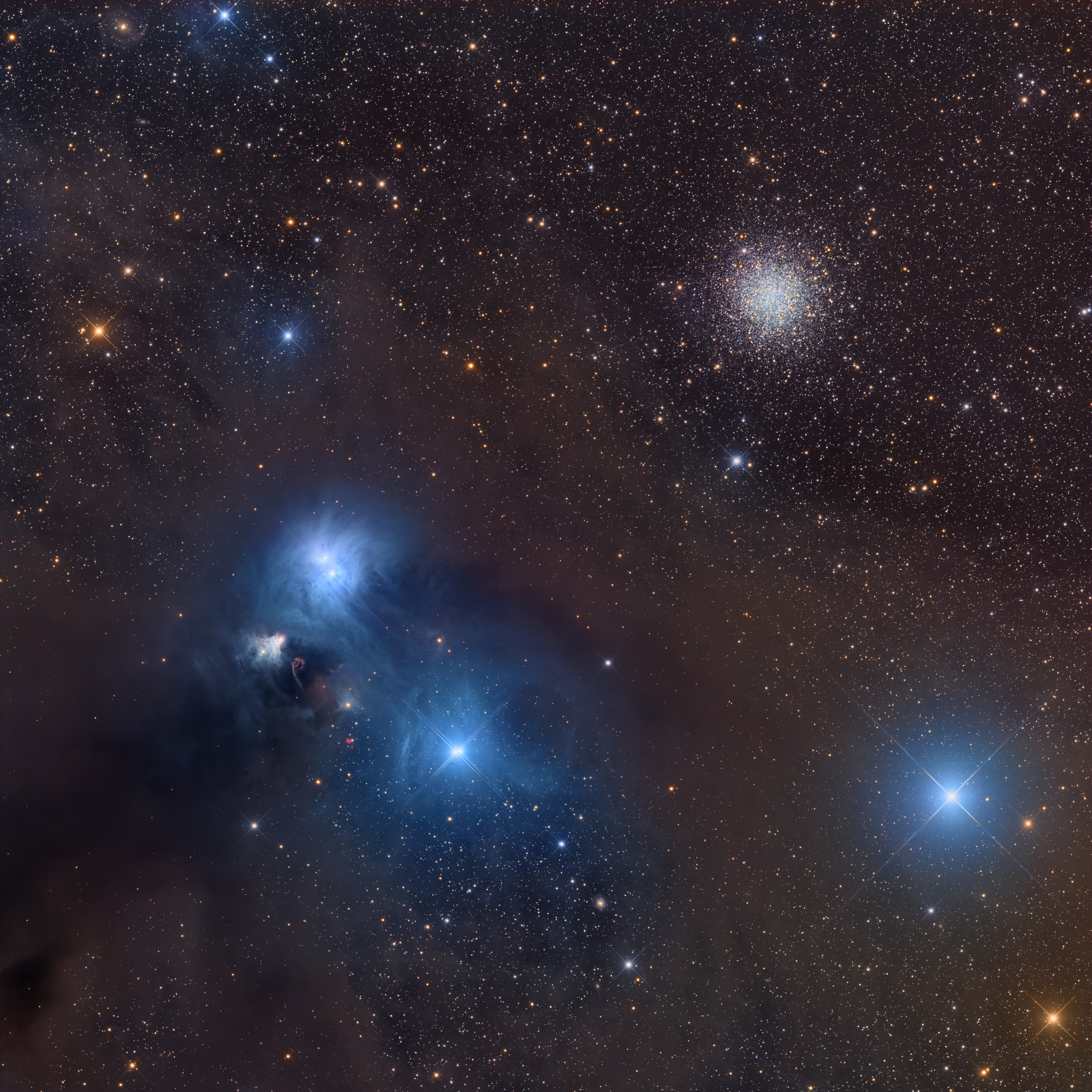 Wide-field view of a rich starfield showing a bright, dense globular star cluster near the upper right and a complex blue nebula with dark dust lanes in the lower left. The globular cluster appears as a tight, glowing ball of countless tiny white stars fading smoothly into the surrounding field. The lower-left nebula is made of bright blue patches around a few standout stars, crossed by thick, irregular dark clouds that block the stars behind them, while the rest of the frame is sprinkled with stars of different brightness and color, including a few very bright stars with sharp diffraction spikes.