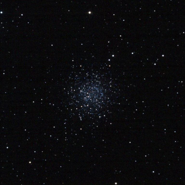 Astrophotograph of NGC 5897, a loose globular cluster appearing as a diffuse, sparkling ball of hundreds of stars — predominantly blue-white — against a black sky background.