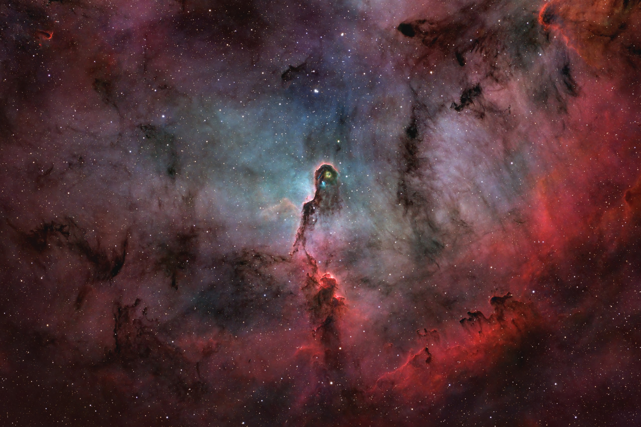 A dark, twisting column of dust with glowing pink edges curls up from the lower part of the frame toward a small, bright knot near the center. It sits amid vast clouds of deep red and dusky blue-gray gas, sprinkled with hundreds of stars across the field.