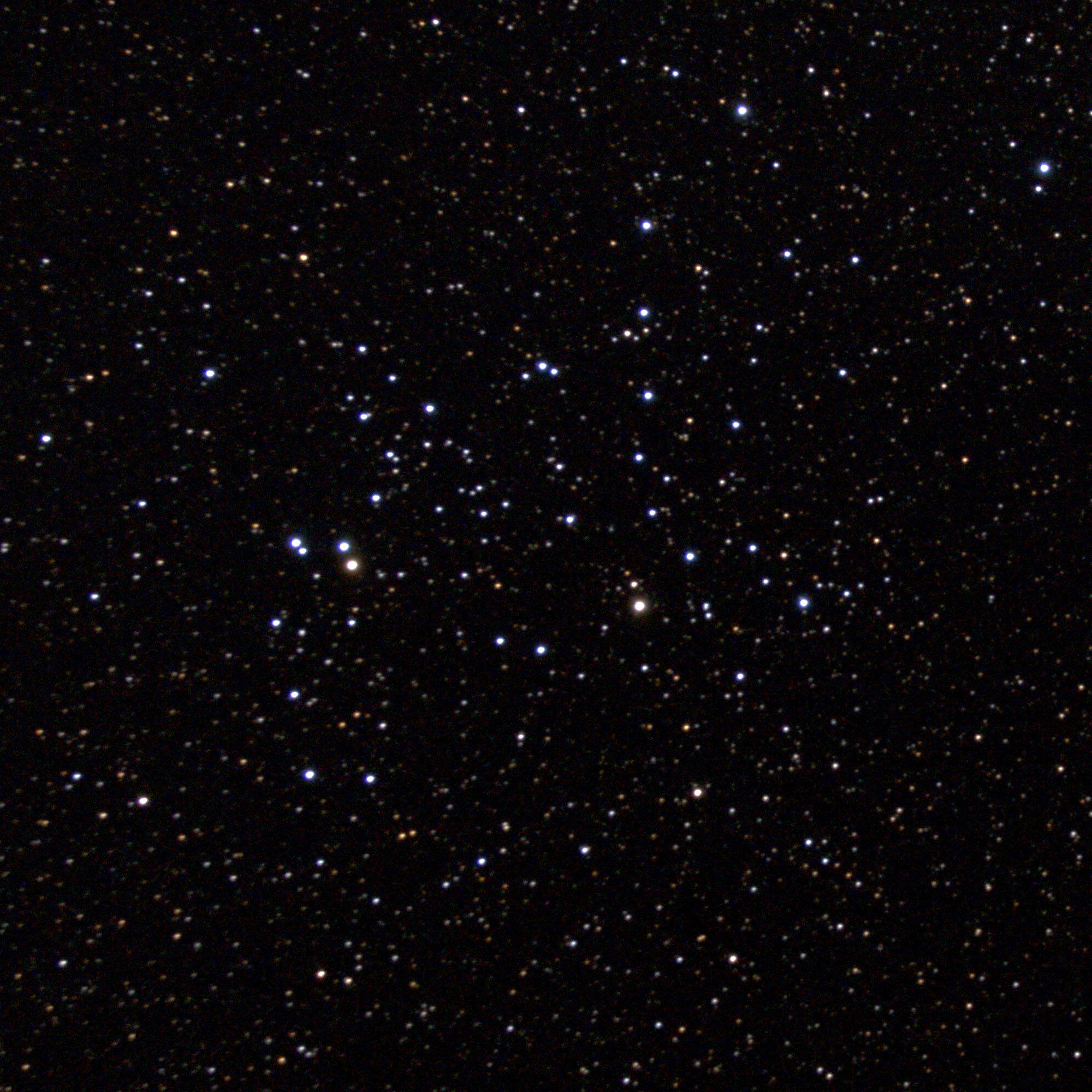 A telescopic photograph of NGC 6709, an open star cluster set against a dense, star-filled black sky. The cluster's members are scattered loosely across the frame, with a mix of bright blue-white stars and fainter orange and yellow background stars, and two noticeably brighter stars near the left-center of the cluster.