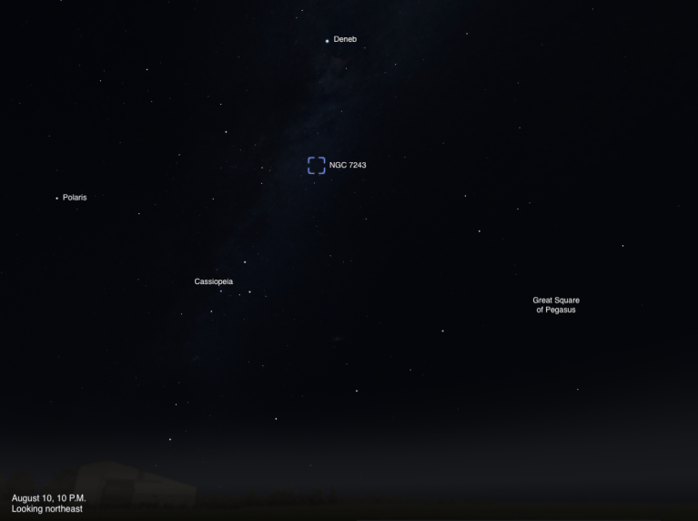 A sky chart showing the northeastern sky on August 10, 2026, at 10 P.M. The open star cluster NGC 7243 is highlighted with a dashed blue box near the center of the image. Deneb is labeled above it, Polaris to the left, Cassiopeia below and to the left, and the Great Square of Pegasus to the lower right. A faint band of the Milky Way is visible near the top of the image.