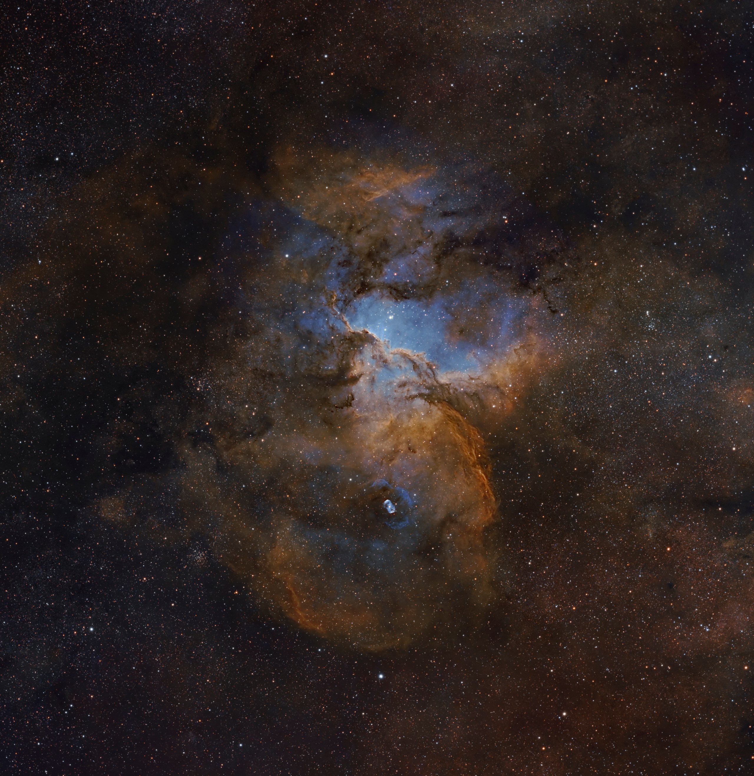 A dark, dust-laced cloud glows red and orange against a dense starfield, with pale blue light seeping through gaps near its center and top. Near the bottom, a small, distinct blue-and-white oval nebula glows within the surrounding dust.
