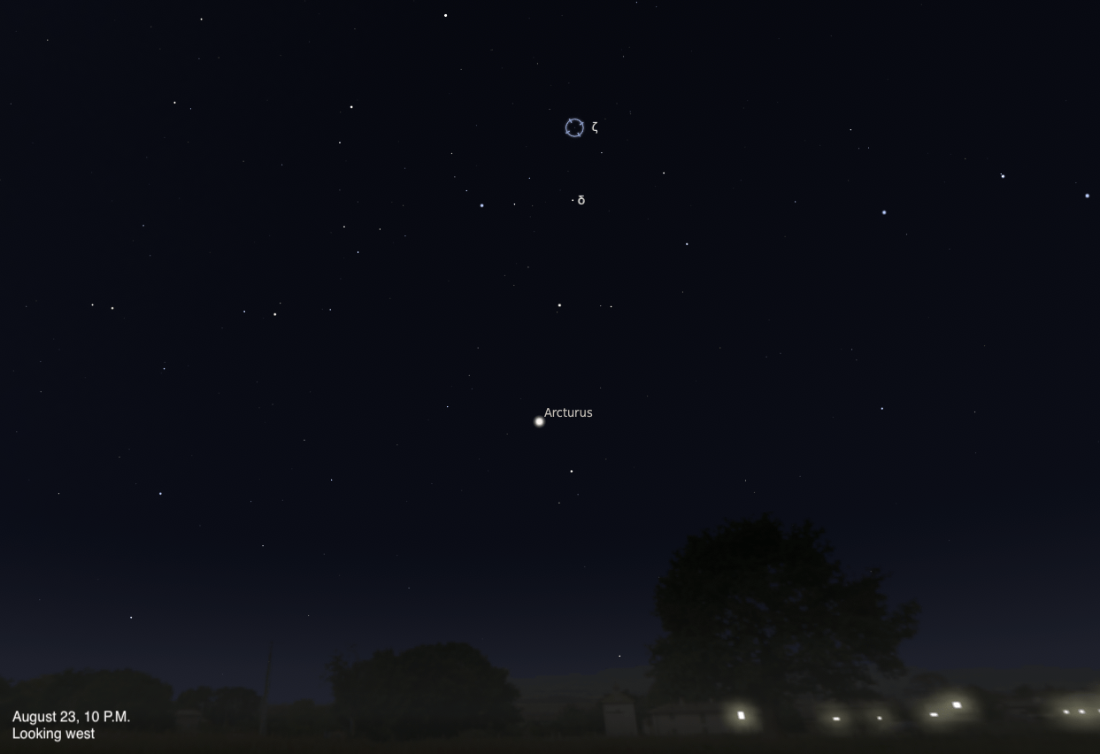 A sky chart showing the western sky on August 23, 2026, at 10 P.M. The recurrent nova T Coronae Borealis (T CrB), also known as the Blaze Star, is highlighted with a circular marker labeled zeta (ζ) near the top center, with delta (δ) labeled just below it. The bright orange star Arcturus is labeled in the middle of the image. Silhouetted trees and faint lights from buildings are visible along the bottom horizon.