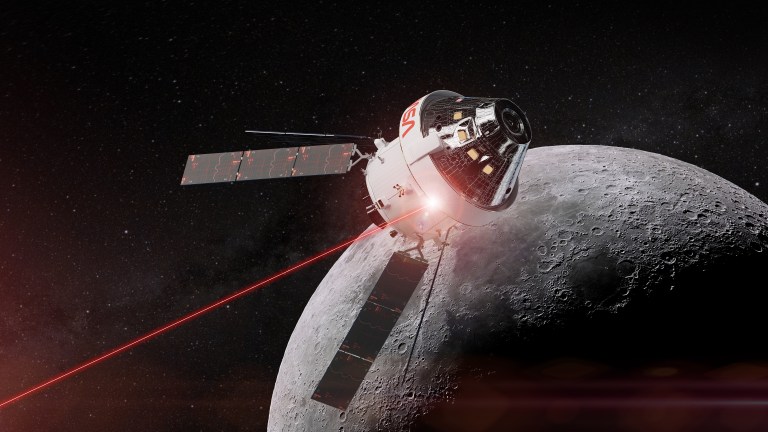 Illustration of NASA’s Orion spacecraft in orbit around the Moon, with a white crew module bearing a red NASA logo atop a service module with extended solar arrays. A thin red laser beam shoots from the spacecraft toward the lower left, representing optical communications. The cratered, partly shadowed Moon fills the lower right against a dark, starry sky.