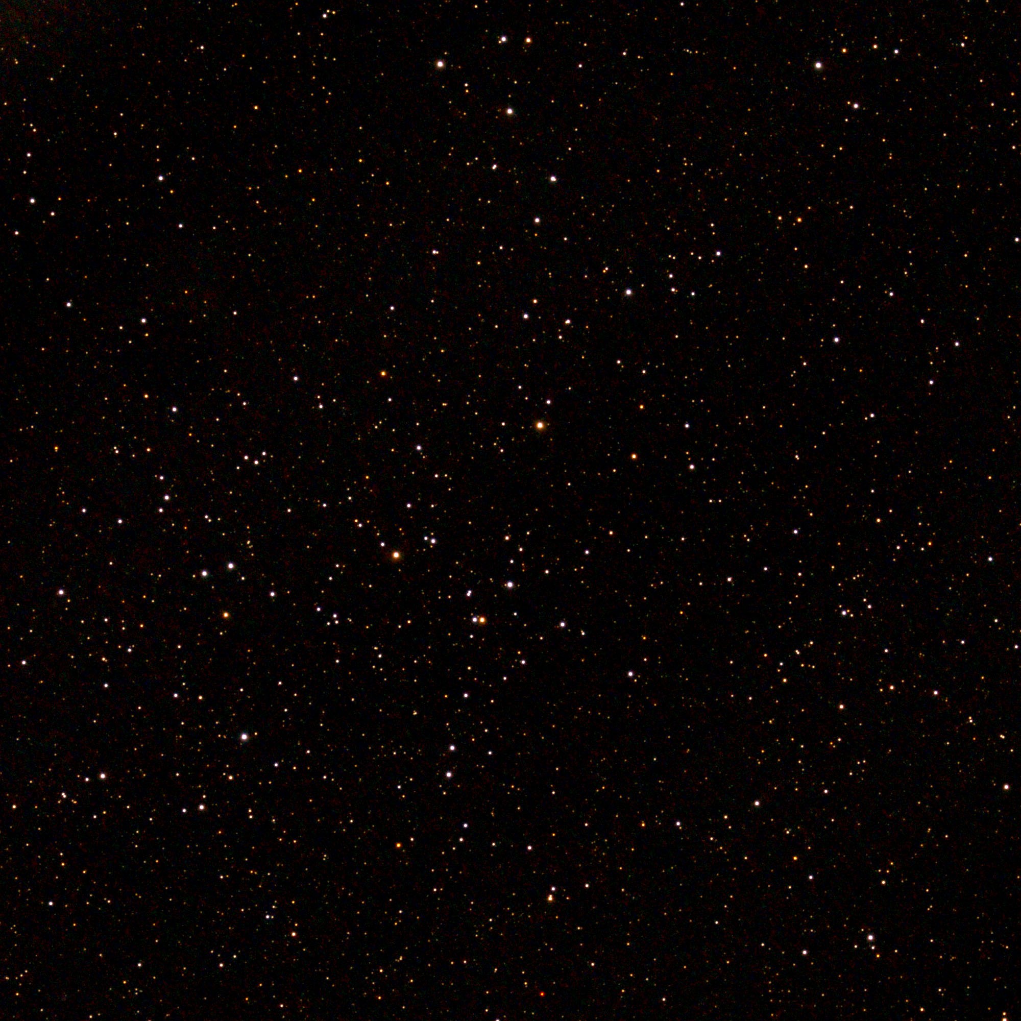 Photograph of the open cluster Collinder 463, a loose scattering of bright white and orange stars across the center of the frame, set against a black sky densely sprinkled with fainter stars.