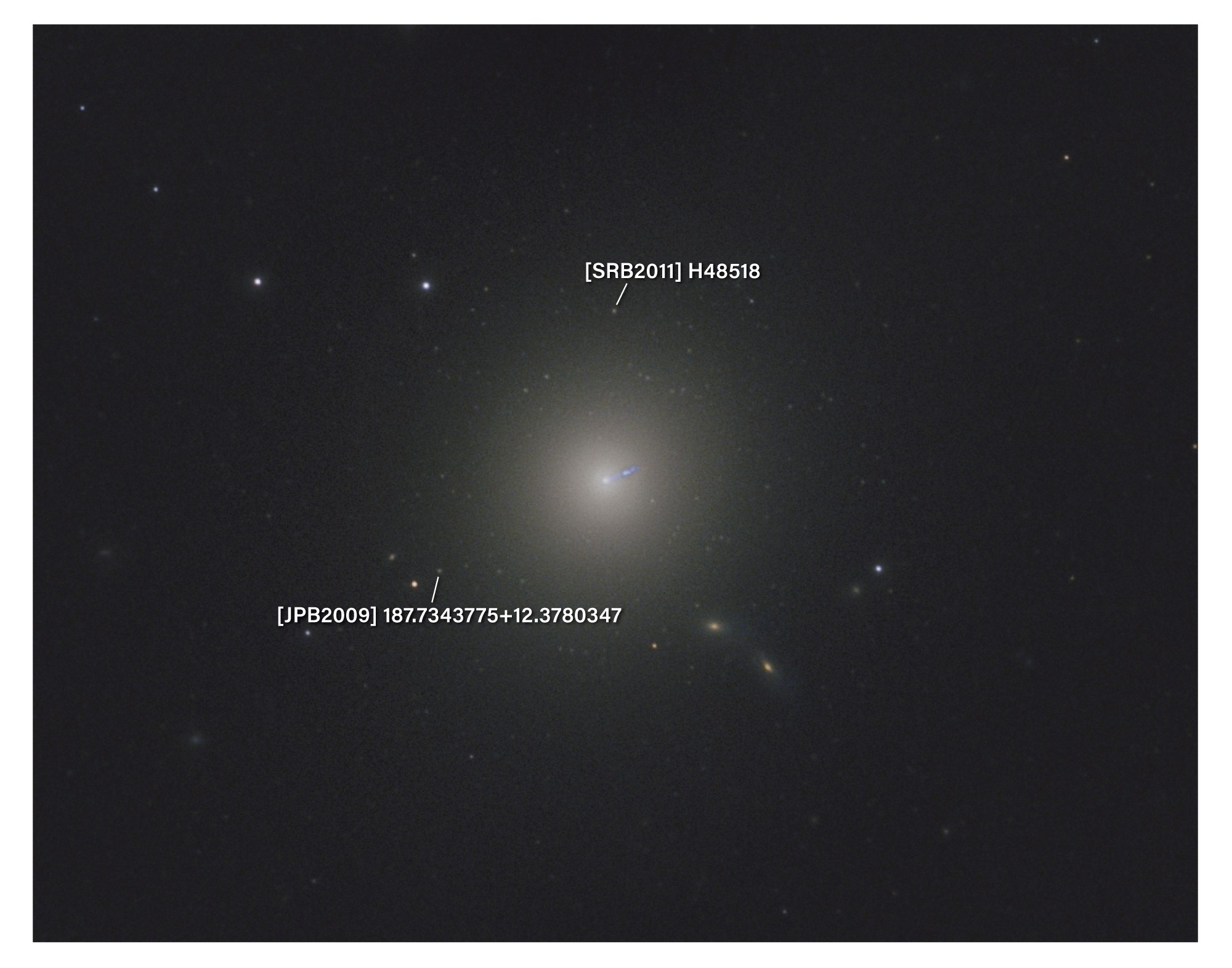 Annotated astrophotograph of the giant elliptical galaxy M87, a large, faint, round yellowish glow at center with a small blue jet streaking from its core. A few small galaxies and stars appear in the surrounding dark field. White leader lines point to two objects labeled [SRB2011] H48518 above the galaxy and [JPB2009] 187.7343775+12.3780347 below and to the left.