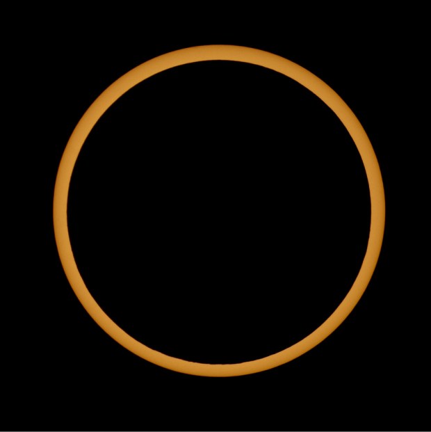 A ring of sunlight remains visible at the midpoint of an annular solar eclipse.