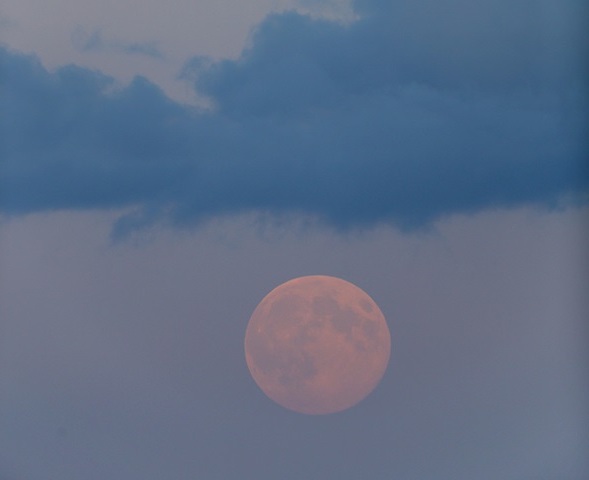 Full moon rising with clouds