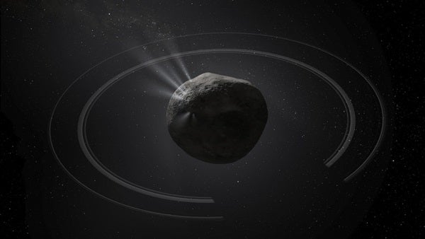Chiron floats in the vastness of space in this illustration, surrounded by a wispy atmosphere that’s fed by the jets of gas and dust emerging from the object’s interior. Credit: Dan Durda.