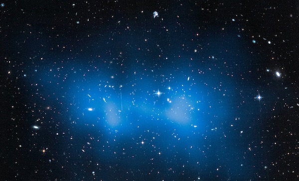 Much of the mass in the El Gordo galaxy cluster is actually dark matter, shown here artificially colorized in blue. Scientists determined the location and concentration of the cluster’s dark matter by observing how its mass distorted the light from distant galaxies behind the cluster. Credit: NASA, ESA, and J. Jee (University of California, Davis).