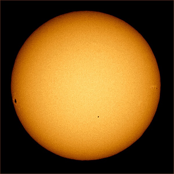 The Sun, seen with limb darkening where the Sun’s circular “edge” appears dimmer than its center.