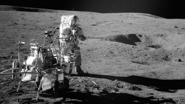 Apollo 14 Astronaut Alan B. Shepard Jr. assembles equipment on the lunar surface in February 1971. Credit: NASA.