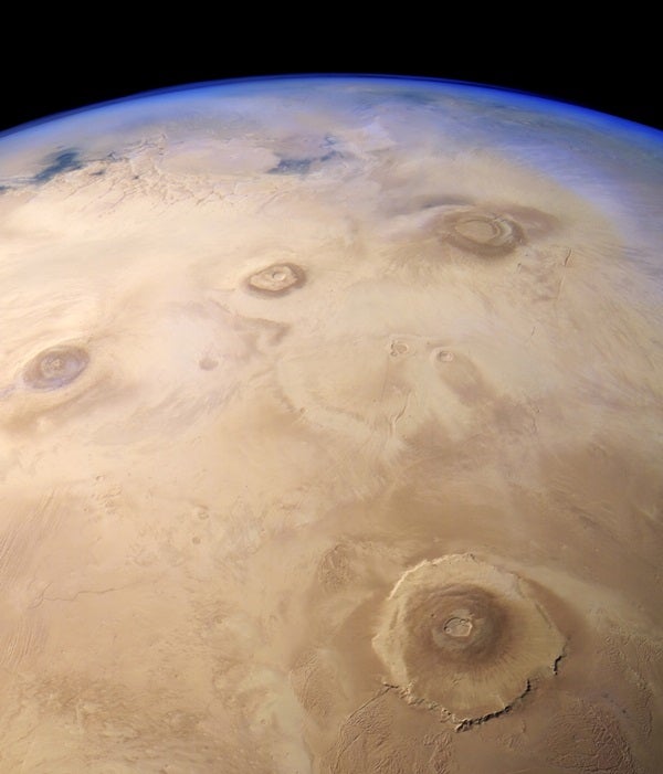 what is the earth end Four massive volcanoes make up the Tharsis Bulge on Mars. The largest of the four, Olympus Mons, is at bottom right. ESA/DLR/FU Berlin/Justin Cowart
