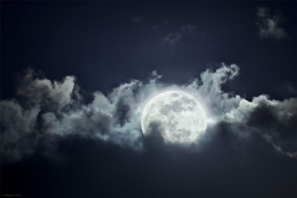 A Full Egg Moon rises among the clouds