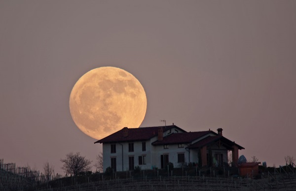 Full Moon rising over a house