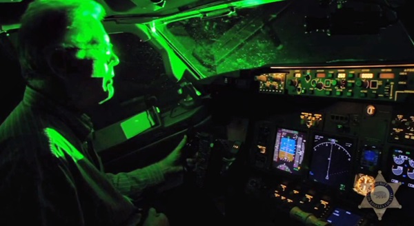 Green laser pointer glare fills a cockpit