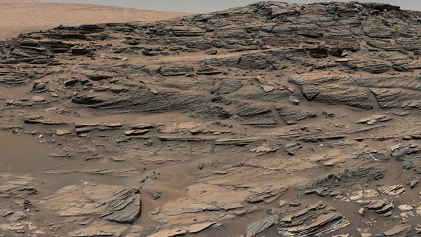 Large-scale crossbedding in the sandstone of this ridge on a lower slope of Mars' Mount Sharp is typical of windblown sand dunes that have petrified.