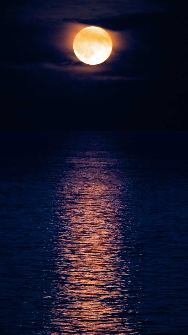 Moon over wavy water