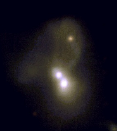 A triple galaxy merger with dual AGN
