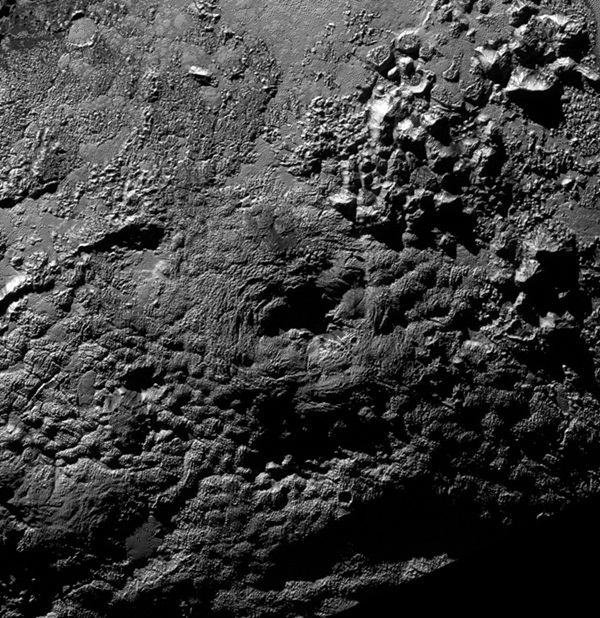 The informally named feature Wright Mons on Pluto is an unusual feature that’s about 100 miles (160 kilometers) wide and 13,000 feet (4 kilometers) high.