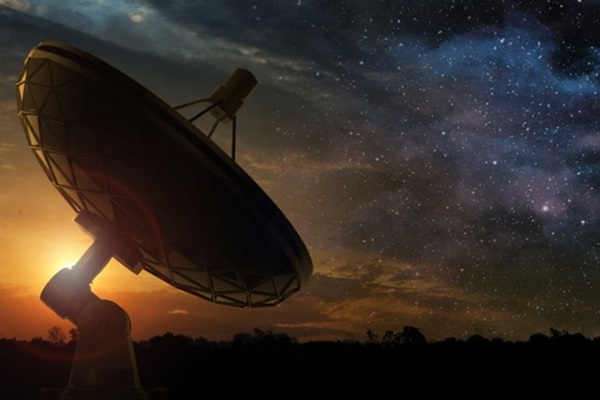 A telescope scans the sky in search of signals sent from advanced alien civilizations in this artist's concept. Credit: paulista/Shutterstock.