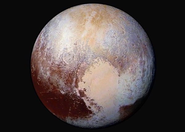 New Horizons captured this color-enhanced view of Pluto from a distance of 280,000 miles (450,000 kilometers) as it flew by the dwarf planet in 2015. Credit: NASA/Johns Hopkins University Applied Physics Laboratory/Southwest Research Institute.