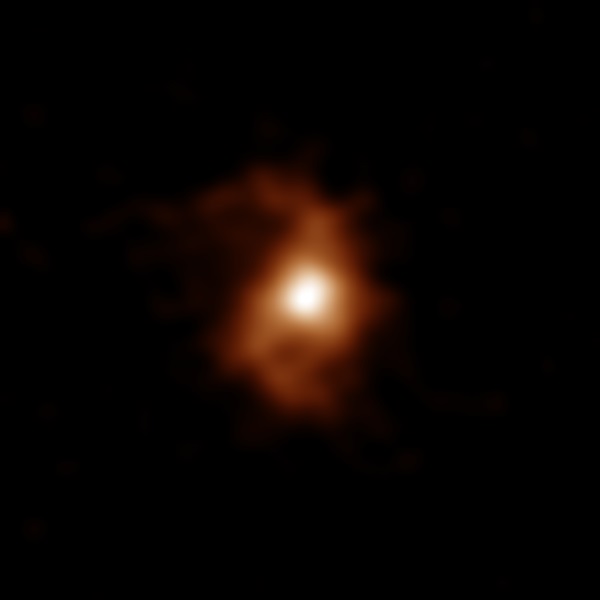 Radio telescope image of a galaxy from the early universe, with a fuzzy core and two wispy spiral arms