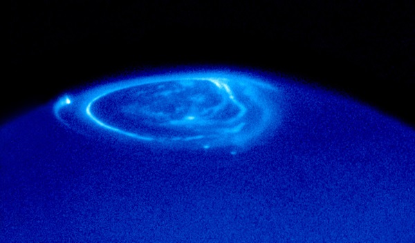 Jupiter's aurorae dance above Jupiter's polar region in this Hubble Space Telescope image taken in 1998. Unlike Earth's aurorae, the charged particles that produce the aurorae at Jupiter come mostly not from the solar wind but from volcanoes on Jupiter's moon Io.