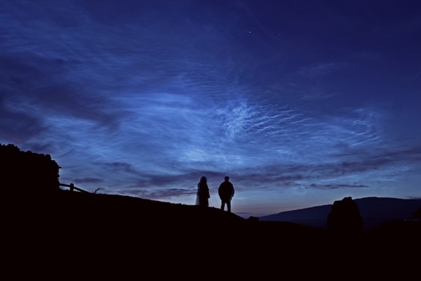 Two observers gaze at noctilucent clouds