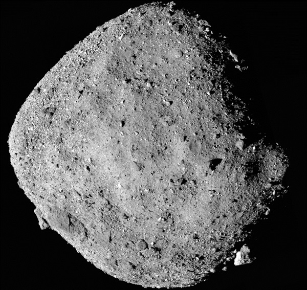 An image taken from a spacecraft of a rocky, cratered, diamond-shaped world so small you can see individual boulders on it.