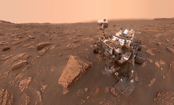 Driving a rover like Curiosity — seen here next to a rock named Duluth — takes careful planning and preparation.