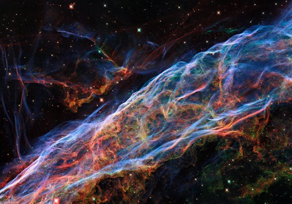 The Veil Nebula, imaged here by the Hubble Space Telescope, lies about 2,100 light-years away in Cygnus.
