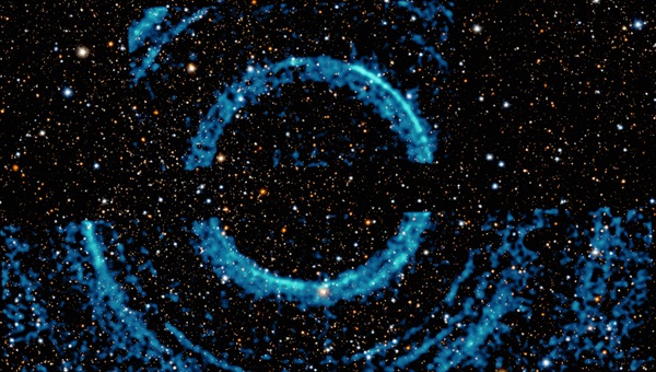 Blue rings of x-ray light surround a black hole. The rings are echoes of light scattered by dust clouds.