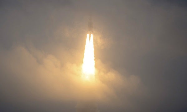 The James Webb Space Telescope rockets to space, folded up inside the fairing of an Ariane 5 rocket.